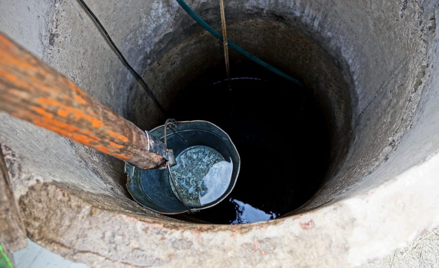 A dry well with water deep down