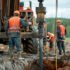 workers drilling a well into the earth